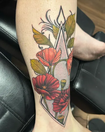 Neo-traditional red poppies with a diamond outline on a forearm — by Adam Crane at Ministry Ink