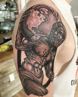 Black and grey cherub statue holding a cracked globe on a shoulder — by Adam Crane