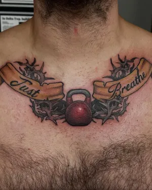 Kettlebell flanked by Just Breathe banner ribbons across the chest — by Adam Crane