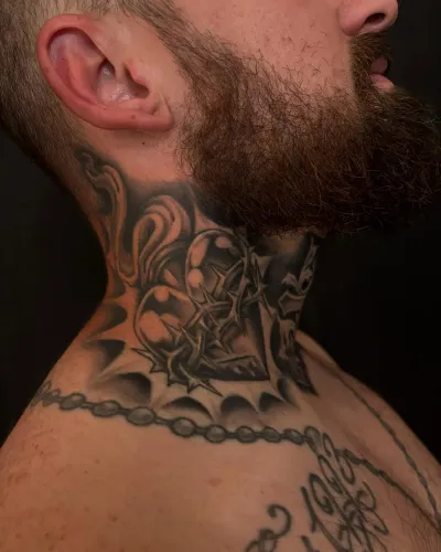 Black and grey ornamental neck and throat piece — by Chay Menke at Ministry Ink