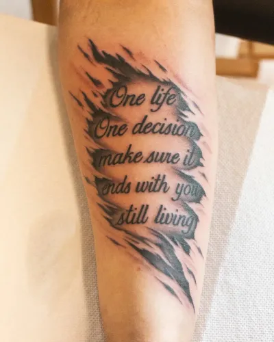 Fine line script reading One life, one decision, on an inner arm — by Chay Menke at Ministry Ink