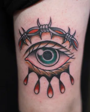 American traditional eye with barbed wire and falling teardrops on a thigh — by Chay Menke