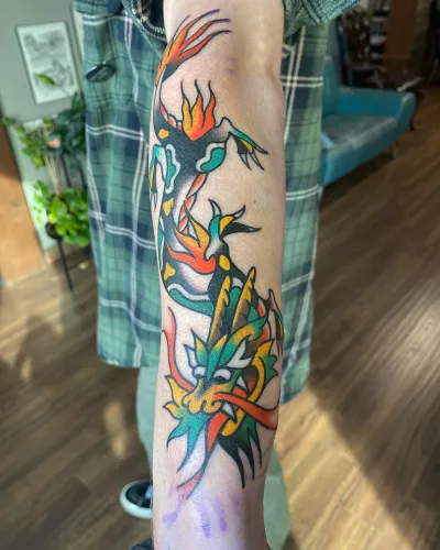 Colour American traditional leg sleeve with flames and flowers — by Chay Menke at Ministry Ink