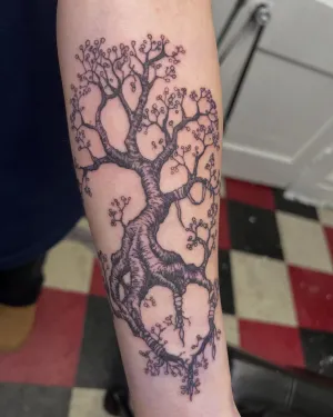 Fine line blossoming tree with delicate branches on a forearm — by Gabriel Gonzalez