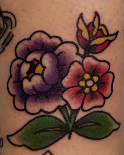 Colour traditional peony and wild rose on a thigh — by Gabriel Gonzalez at Ministry Ink