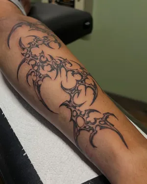 Fine line thorned vine wrapping a forearm — by Gabriel Gonzalez